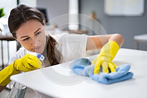 Worker Cleaning Desk With Rag