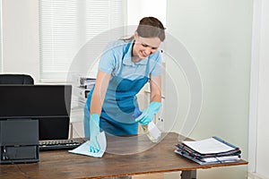 Worker Cleaning Desk With Rag photo