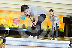 Worker cleaning floor in empty storehouse