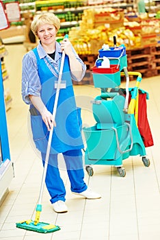 Worker cleaning floor with mop