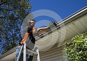 Worker Cleaning Gutters