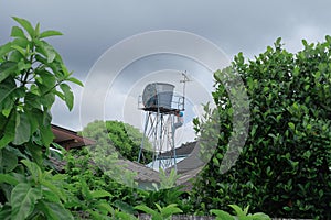 Worker cleaning in water tank on the tower. water storage