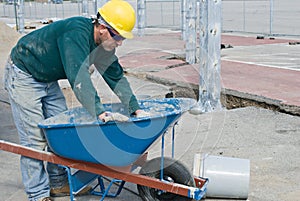 Worker Cleaning Wheel Barrow