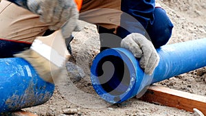 Worker cleans pipes for lubrication by brush