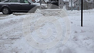 Worker cleans snow from sidewalks with snow blower machine after snow storm. 4K