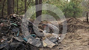 A worker clears the forest of debris