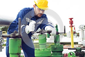 Worker closes the valve on the oil pipeline