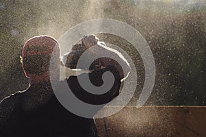 Worker in Cloud of Sawdust photo