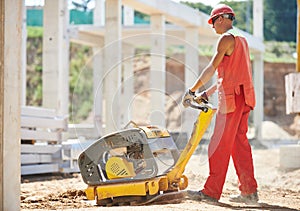 Worker with compaction machine photo