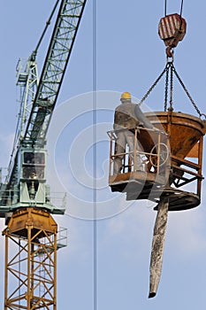 A worker in a concrete bucket