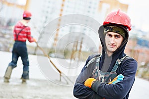 Worker during concrete work at costruction site