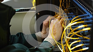 Worker connects optical line internet wire in connection box. Service man soldering optical fiber. Internet service