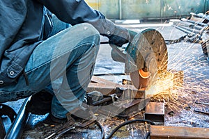 Worker in constructing industry grinding metal