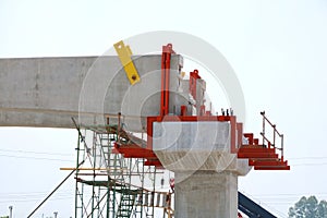 Worker constructing railways structure for electric train on blue sky as a background in the construction site