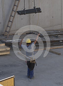 Worker with construction crane with heavy load