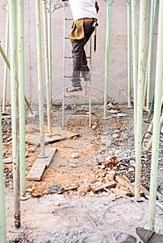 Worker on a construction site cleaning the area of rubble and garbage