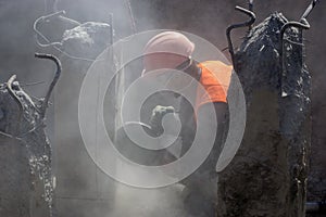 Worker at the construction site cuts concrete