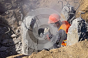 Worker at the construction site cuts concrete