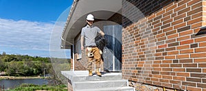 A worker at a construction site holds an electrical cable