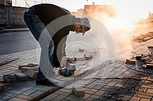 Worker at the construction site saws building materials