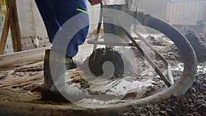 Worker at a construction site screed floor. Leveling semi-dry floor screed.