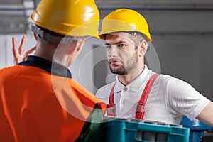 Worker consulting with manager in factory