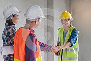 Worker and contractor. Client shaking hands with team builder in renovation site