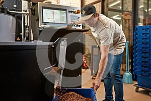 Worker control coffee making process on factory