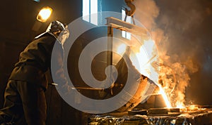 Worker controlling metal melting in furnaces. Workers operates at the metallurgical plant.