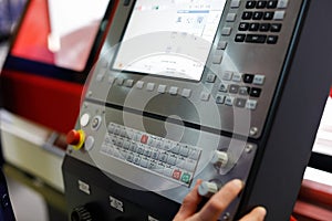 Worker controls the operation of the CNC machine