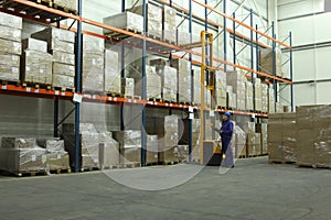 Worker counting stocks in warehouse