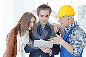 Worker and couple using tablet pc