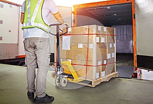 Worker Courier Unloading Package Boxes into Cargo Container. Delivery service. Truck Loading at Dock Warehouse. Shipping Boxes.