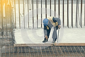 Worker with crowbar removing wooden formworks 2
