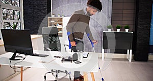 Worker With Crutches At Workplace Or Office photo