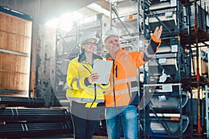 Worker and customer discussing business in logistics center