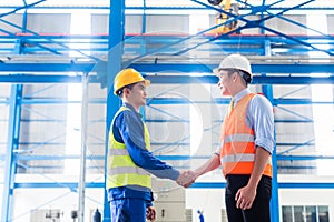 Worker and customer having agreement in factory