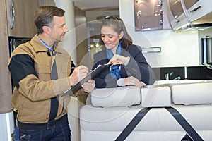 Worker and customer in interior luxury motorhome