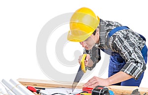 A worker cut a plank with a hand saw