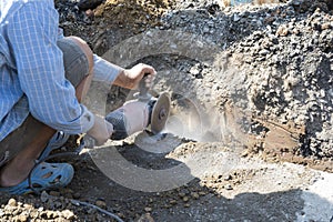 worker cut road by grinder