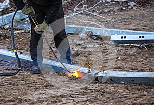 A worker cut steel beams using propane-oxygen torch..Oxy-fuel cutting