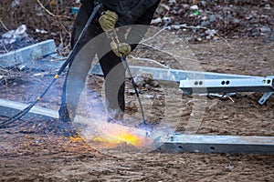 A worker cut steel beams using propane-oxygen torch..Oxy-fuel cutting