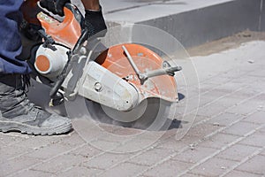 A worker cuts with a circular saw.