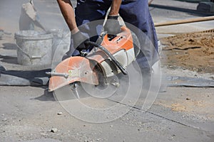 A worker cuts with a circular saw.