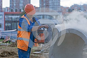 Worker cuts the concrete ring