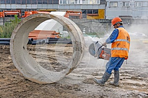 Worker cuts the concrete ring