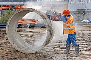Worker cuts the concrete ring