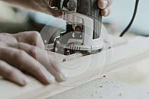 worker cuts the door hinge, milling cutter photo