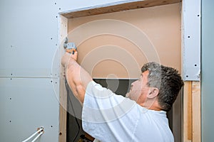Worker cuts drywall with a using multi tool