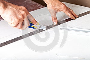 Worker cuts with a knife drywall repair